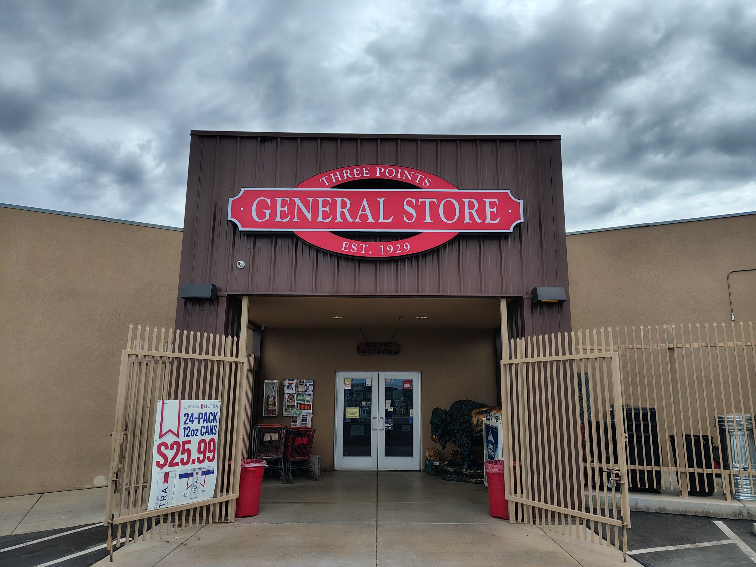 Custom illuminated red channel letter sign with acrylic face and trim cap reading Three Points General Store Est. 1929 installed on commercial building facade.